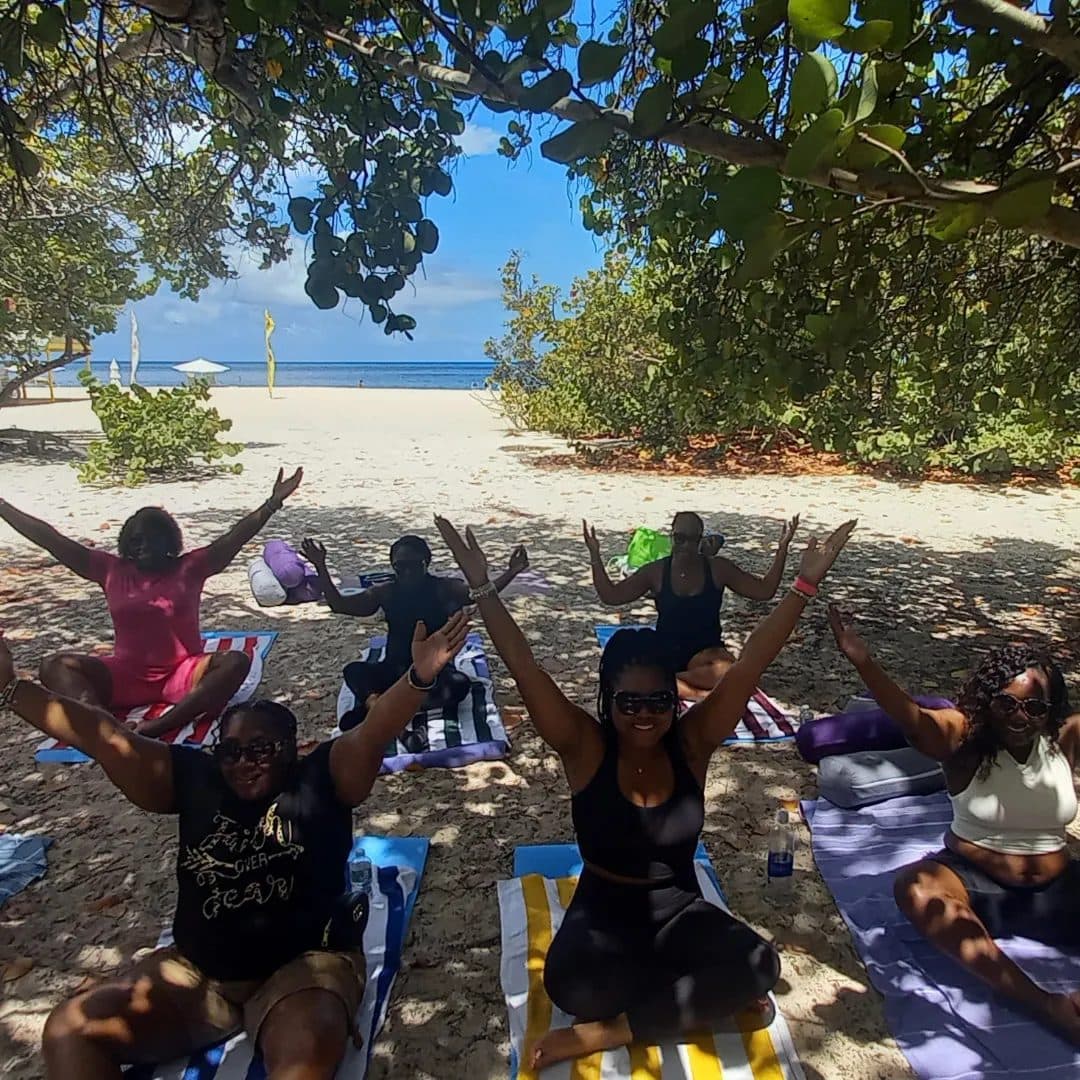 A joyful class with arms in the air under the sea grape trees