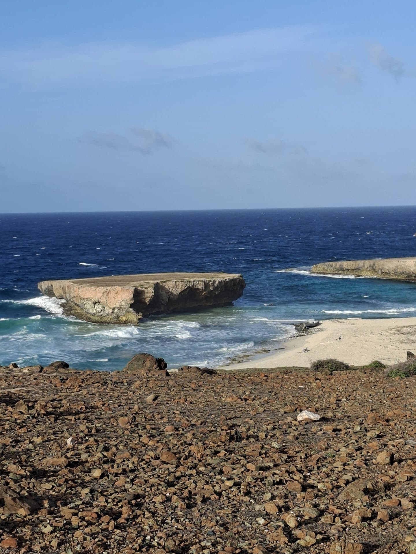 The rugged north coast cove and natural rock bridge with no one else around