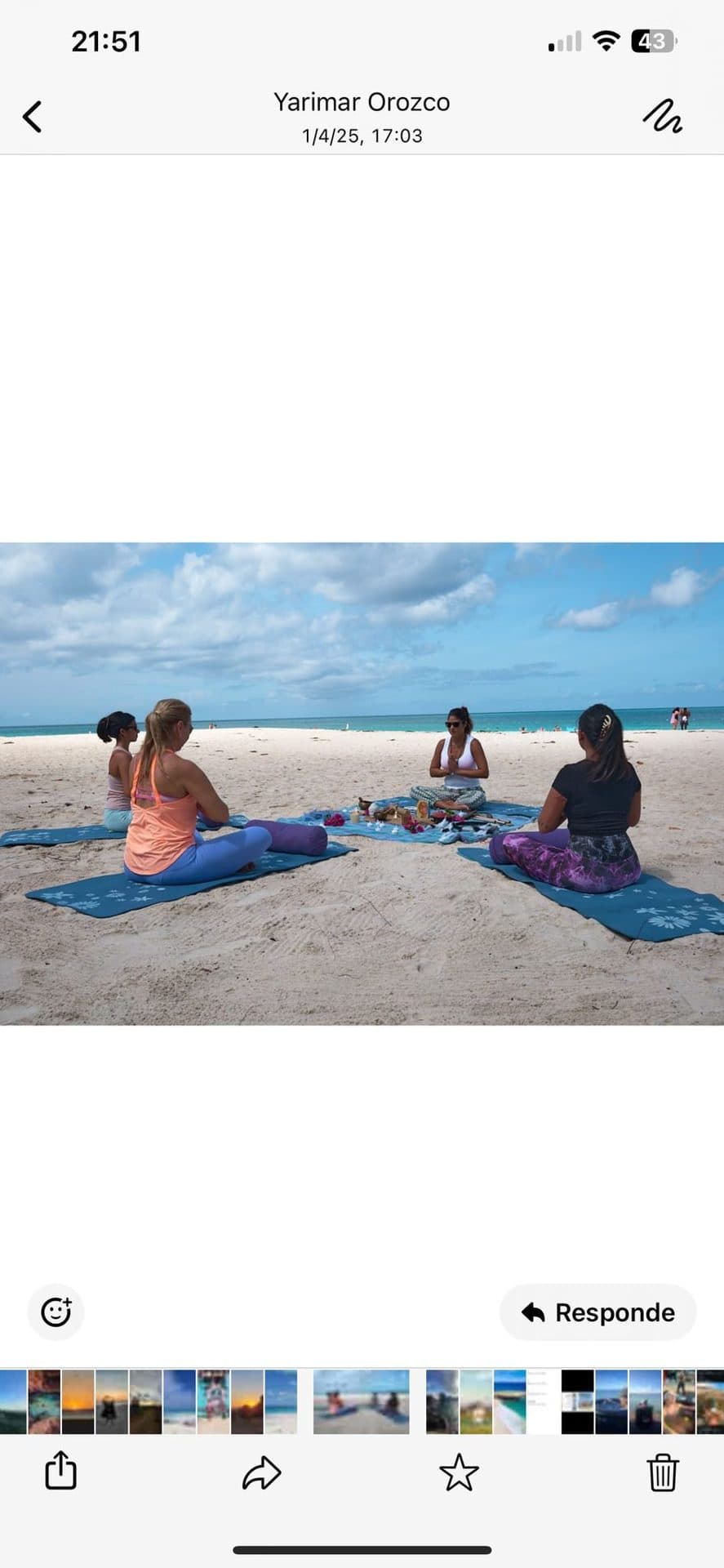 A small circle of guests seated on the open sand of Eagle Beach
