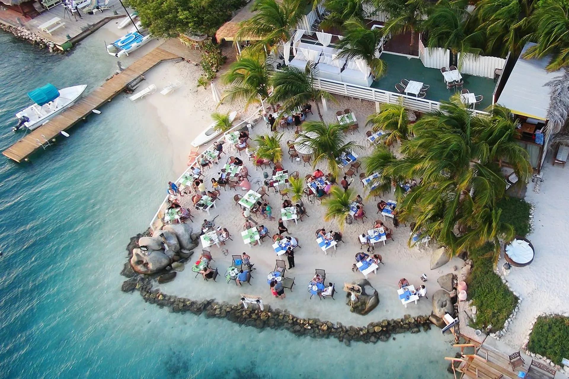 Aerial photograph of Flying Fishbone’s tables beside the sea in Savaneta, Aruba