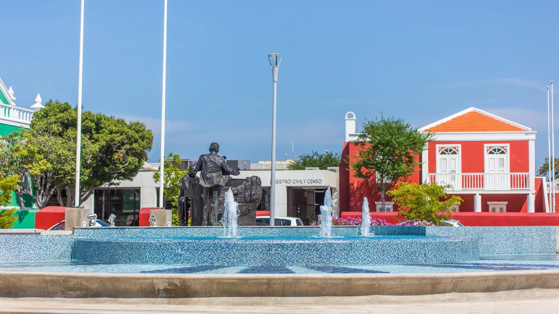 Plaza Padu, its fountain and colourful buildings in central Oranjestad, Aruba